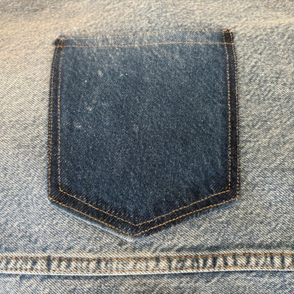 Close-up of a blue denim pocket on a jeans fabric.